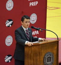 Declamations 8th grade winner addresses student body at podium