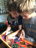 two boys reading a book together