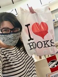 Diana Rendina, Media Specialist holds a bag of books.