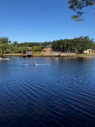 Tampa Prep crew member rows on a lake